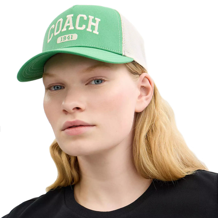 Female model wearing Coach 1941 Embroidered Trucker Hat Kelly CAA61