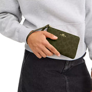 Model Carrying Coach Corner Zip Wristlet In Signature Canvas - Olive CAQ75