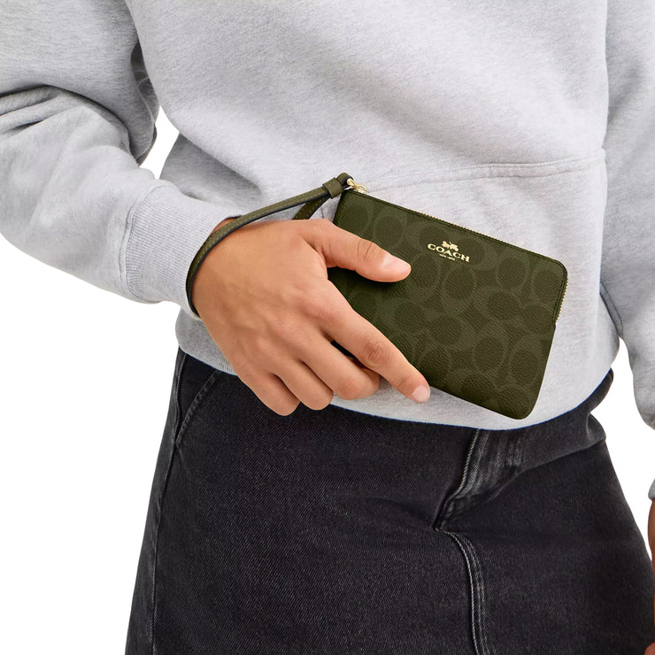 Model Carrying Coach Corner Zip Wristlet In Signature Canvas - Olive CAQ75