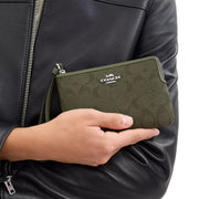 Model View of Coach Corner Zip Wristlet In Signature Jacquard - Olive Drab/ Olive Drab CW862