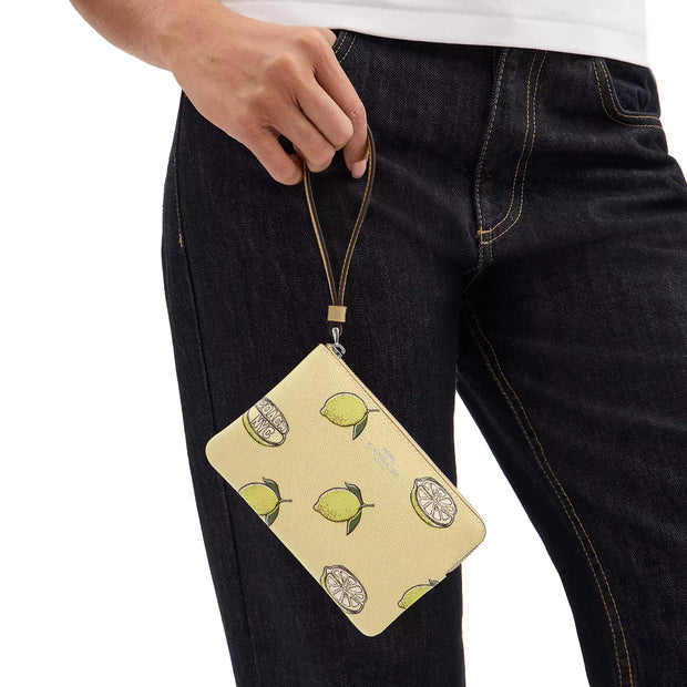 Model Holding Coach Corner Zip Wristlet with Lemon Print - Garden Glade Multi CBB80