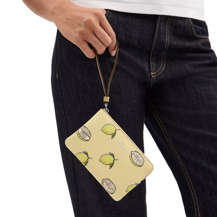 Model Holding Coach Corner Zip Wristlet with Lemon Print - Garden Glade Multi CBB80