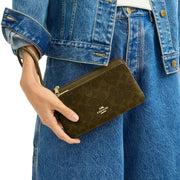 Model Wearing Coach Double Zip Wallet In Signature Canvas - Olive CX161