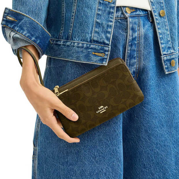 Model Wearing Coach Double Zip Wallet In Signature Canvas - Olive CX161