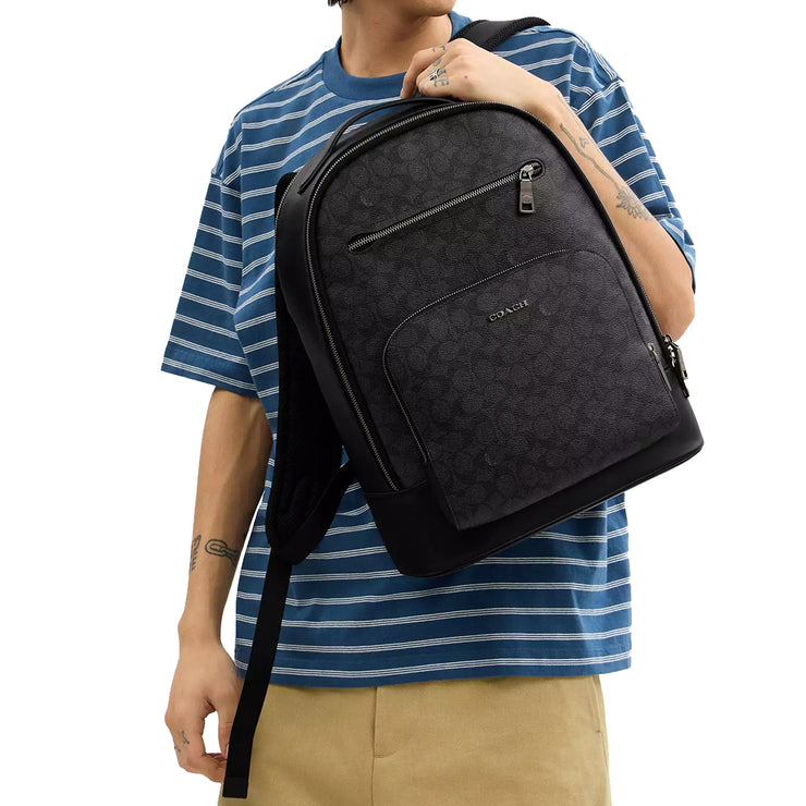 Male Model carrying Coach Ethan Backpack Bag In Signature Canvas - Charcoal/ Black CY832