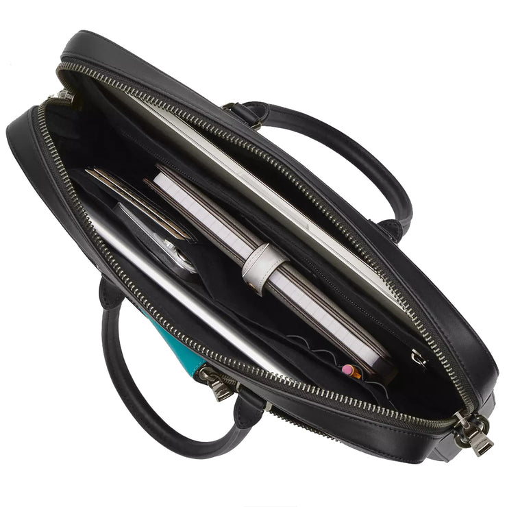 Interior view of Coach Ethan Slim Brief Bag in Black CR271, shown with organized contents including tech accessories and documents