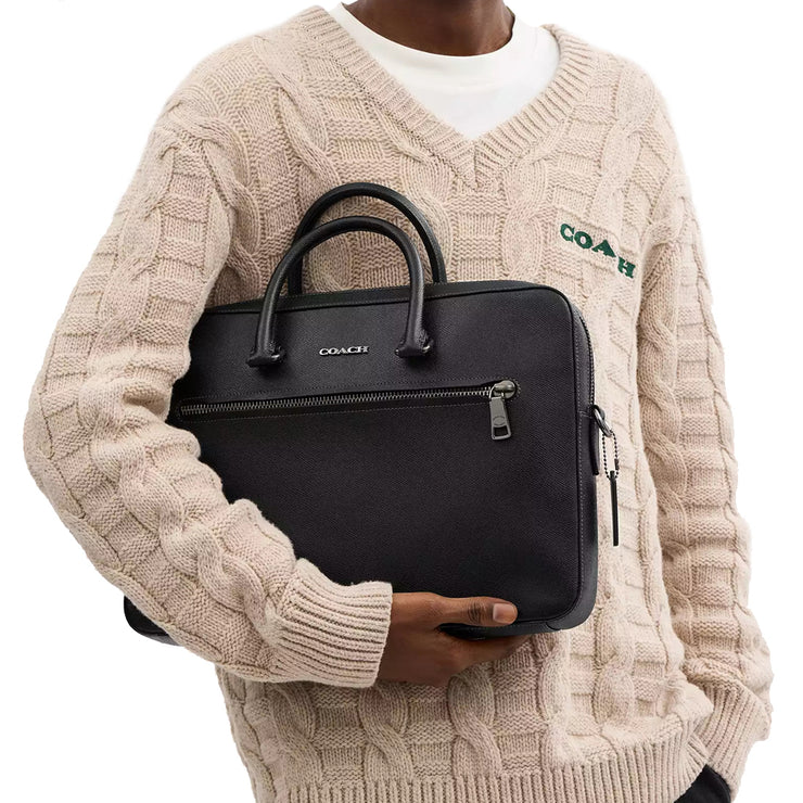 Male model carrying Coach Ethan Slim Brief Bag in Black CR271 in his arms