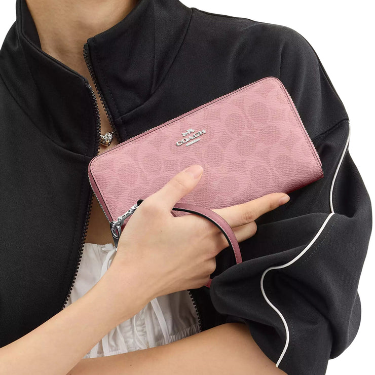 Model Carrying Coach Long Zip Around Wallet In Signature Canvas - Dusty Pink CW778
