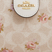 Closeup of Coach Medium Corner Zip Wallet In Signature Canvas With Floral Print - Sand Multi CAR13