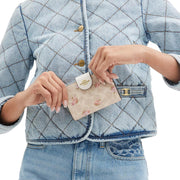 Model Holding Coach Medium Corner Zip Wallet In Signature Canvas With Floral Print - Sand Multi CAR13