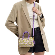 Model Carrying Coach Mini Rowan Crossbody Bag With Floral Print - Lilac Multi CBM69