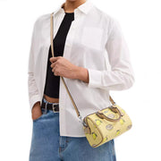 Model Wearing Coach Mini Rowan Crossbody Bag With Lemon Print - Garden Glade Multi CAL19