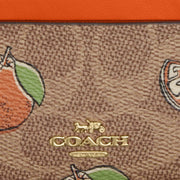Closeup of Coach Mini Skinny Id Case In Signature Canvas With Orange Print - Tan Multi CAR21