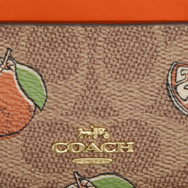 Closeup of Coach Mini Skinny Id Case In Signature Canvas With Orange Print - Tan Multi CAR21