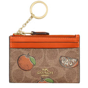 Front View of Coach Mini Skinny Id Case In Signature Canvas With Orange Print - Tan Multi CAR21