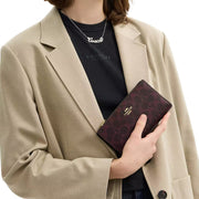 Model Wearing Coach Slim Zip Wallet In Signature Canvas - Black Currant CW661