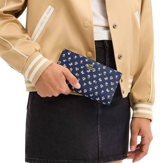 Model Carrying Coach Slim Zip Wallet With Floral Print - Deep Blue Multi CBO24