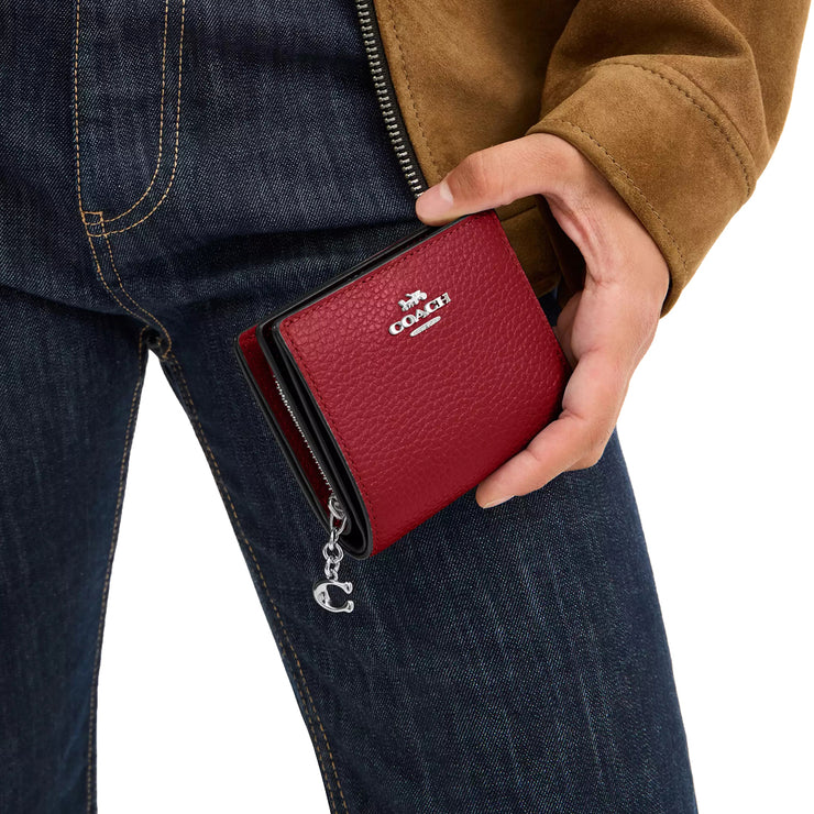 Model Holding Coach Snap Wallet - Dark Cardinal CBO77