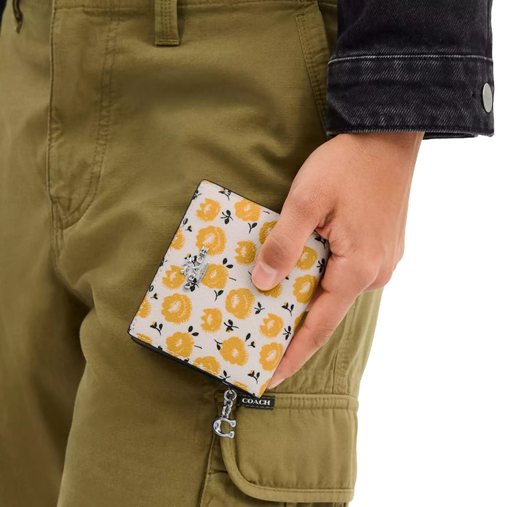 Model Carrying Coach Snap Wallet With Floral Print - Chalk/ Buttercup Multi CBO76
