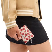 Model Holding Coach Snap Wallet With Floral Print - Chalk/ Black Multi CBO76