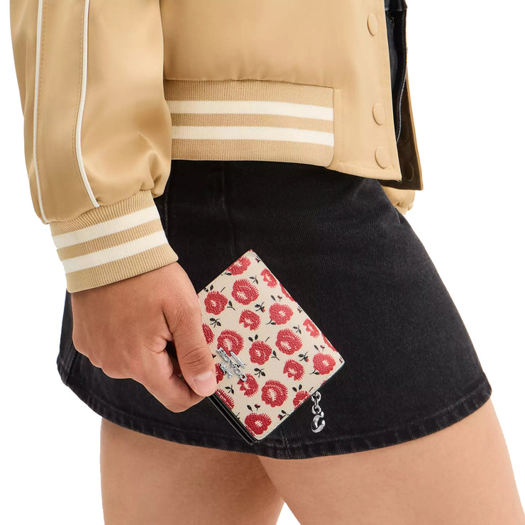 Model Holding Coach Snap Wallet With Floral Print - Chalk/ Black Multi CBO76