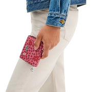 Model Holding Coach Snap Wallet With Floral Print - Pink Multi CBO75