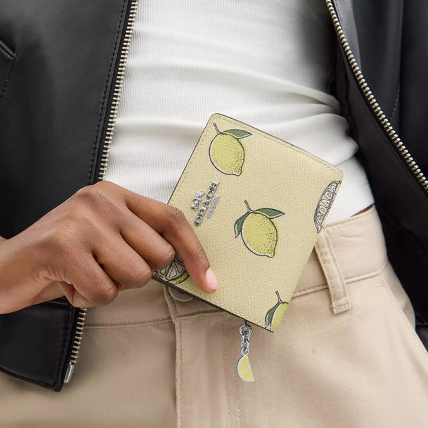 Model View of Coach Snap Wallet With Lemon Print - Garden Glade Multi CAP19