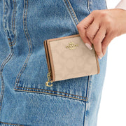 Model View of Coach Snap Wallet With Signature Canvas - Dark Natural Multi CAP12