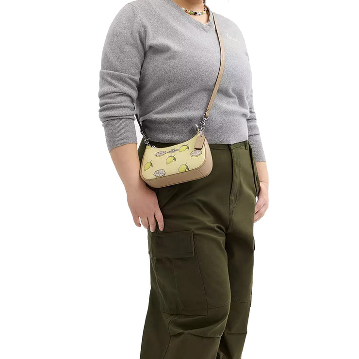 Model Wearing Coach Teri Mini Crossbody Bag With Lemon Print - Garden Glade Multi CAL21
