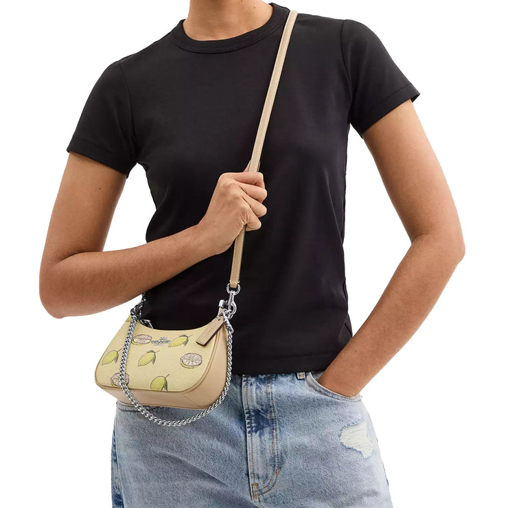 Model Wearing Coach Teri Mini Crossbody Bag With Lemon Print - Garden Glade Multi CAL21