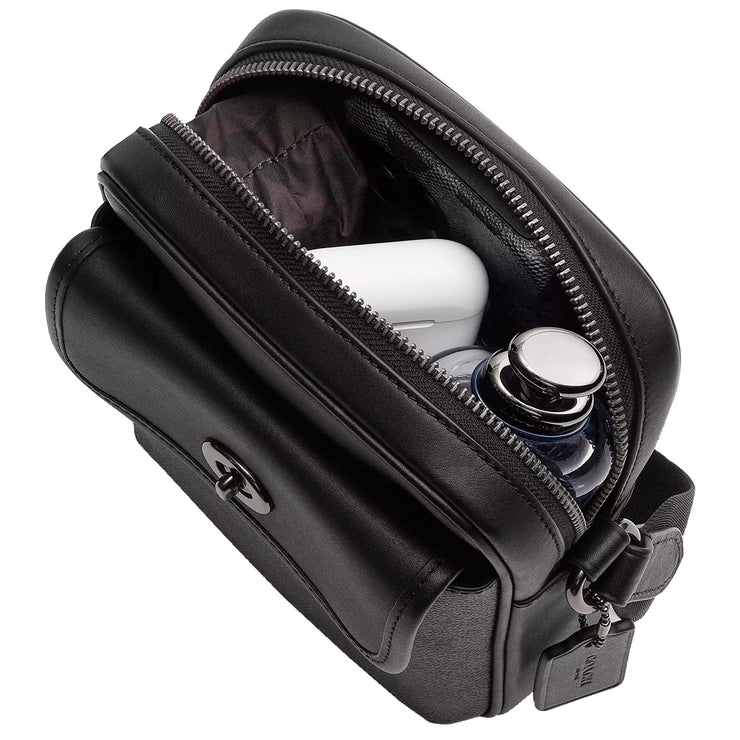 Interior view of Coach Turnlock Crossbody Bag In Signature Canvas - Charcoal/ Black CAJ30, shown with organized contents including tech accessories, small water bottle & small umbrella