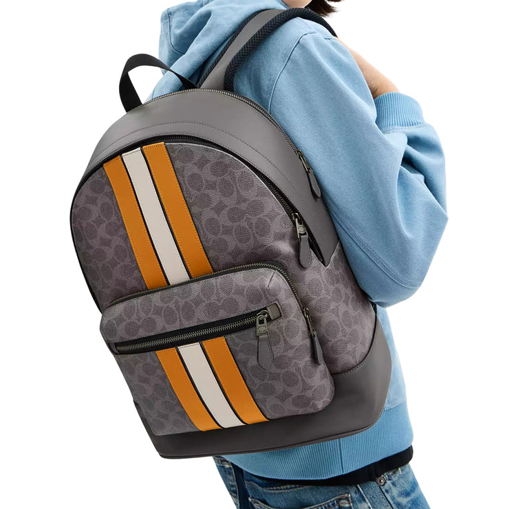 Model Wearing Coach West Backpack Bag In Signature Canvas With Varsity Stripe - Grey/ Ochre/ Chalk CV922