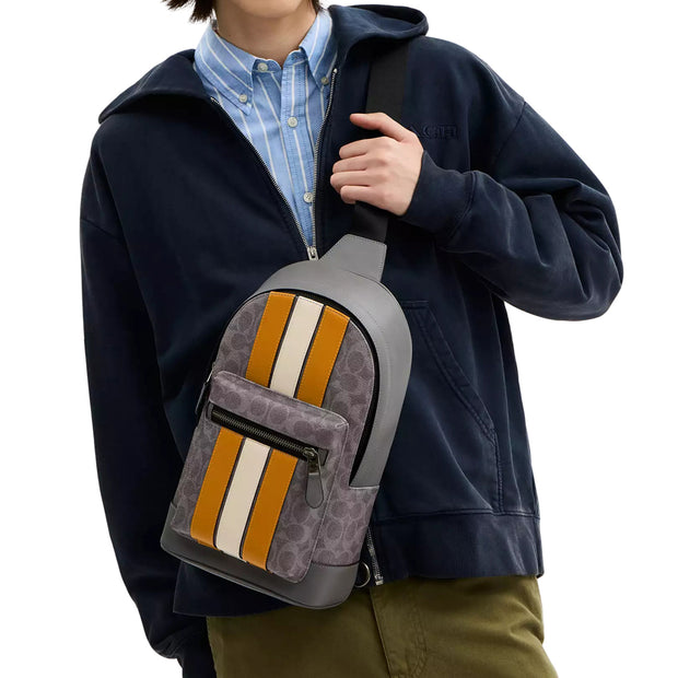 Model Wearing Coach West Pack Bag In Signature Canvas With Varsity Stripe Bag - Grey/ Ochre/ Chalk CV923
