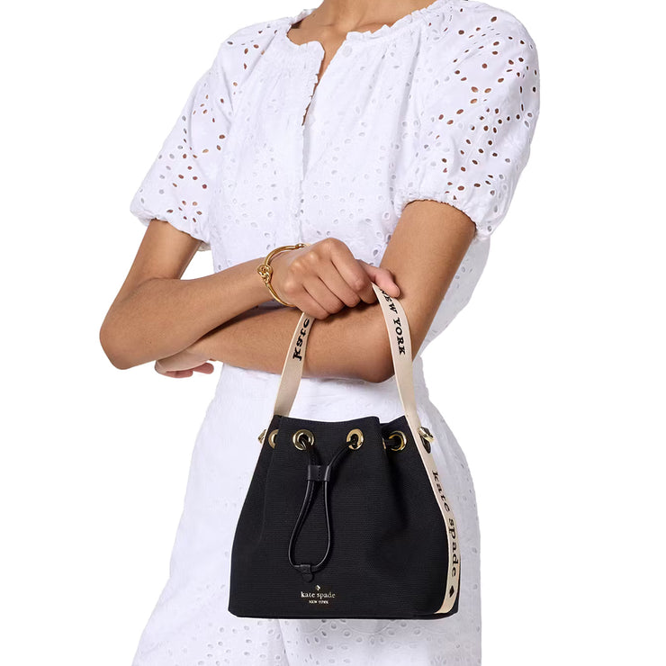 Model Holding Kate Spade Kip Canvas Bucket Bag - Black KL048
