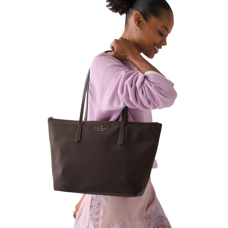 Model Carrying Kate Spade Kitt Nylon Medium Tote Bag - Hot Fudge KC455