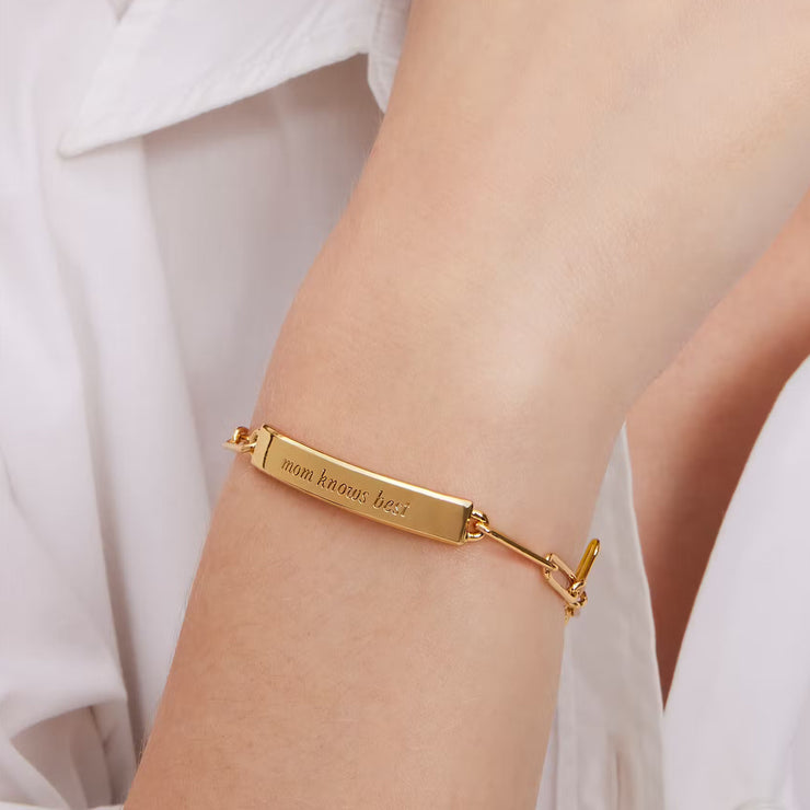 Closeup of Female Model Wearing Kate Spade Mom Knows Best Idiom Id Bracelet in Gold KG408